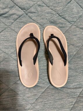 OluKai flip flops in gray and navy